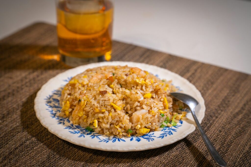 white ceramic plate with rice and stainless steel fork