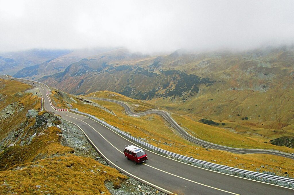 aerial photography of white and red vehicle on road during daytime