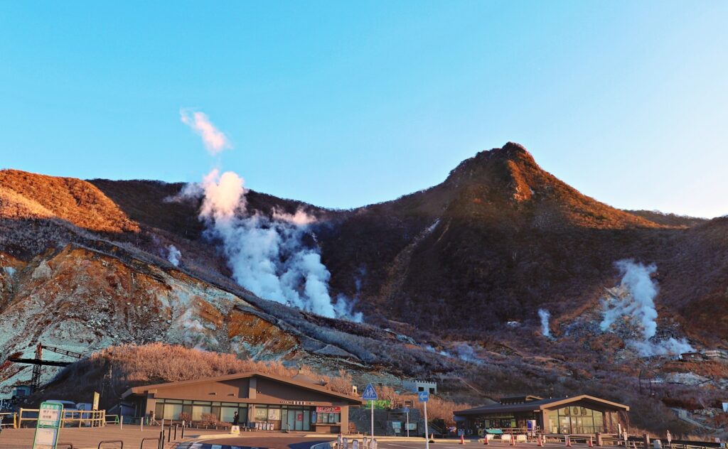 gray house under brown mountain during daytime